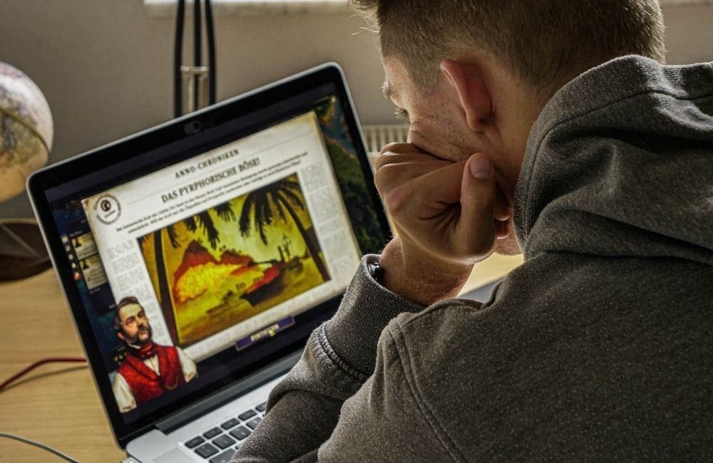 An image of a man reading a blog. 