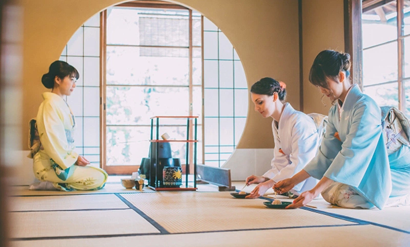 Japanese tea ceremony with host whisking matcha tea.