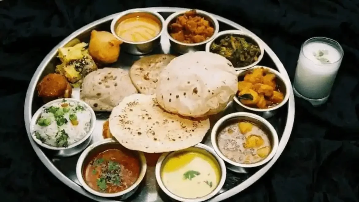 Assorted Indian dishes arranged on a round plate, showcasing diverse regional cuisines