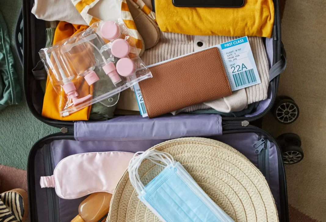 Traveler packing essentials in natural daylight before a long flight to minimize jet lag and prepare for smooth time zone adjustment.