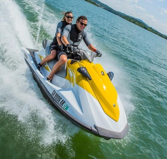 Tourists jet skiing rapidly across the water, emphasizing the exciting water activities available during Mombasa travel.